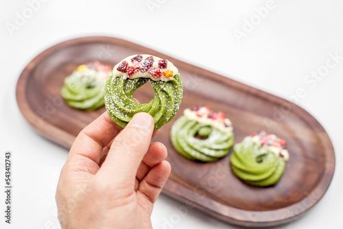 Person's hand holding a round Christmas cookie
