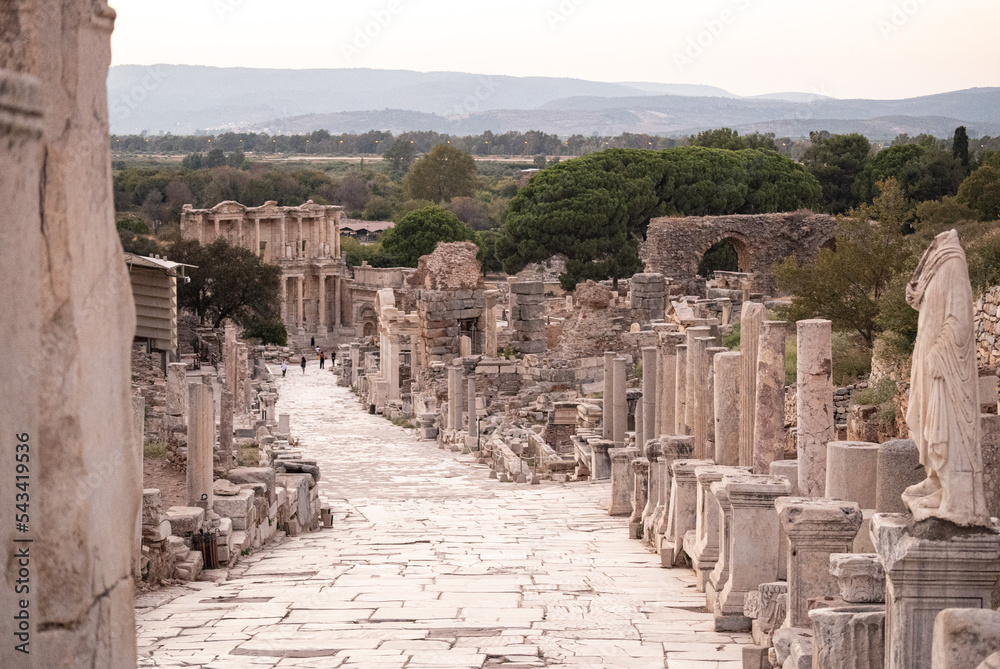 Big ancient stone pathway with columns and ruins around leading to the ruins of Ephesus, in Turkey 