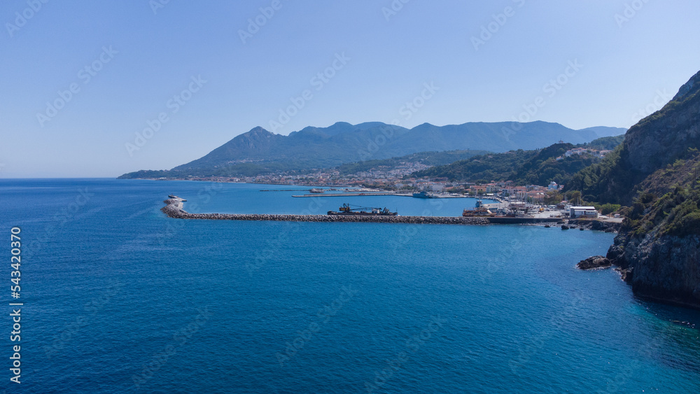 Aerial footage of shipyard in Karlovasi, Samos island behind wave breakers on a clear summer morning