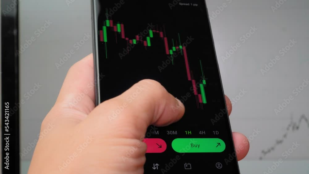 Businessman trader investor analyst using mobile phone application to analyze cryptocurrency financial market, chart index of trading data on smartphone. in background runs graph on display