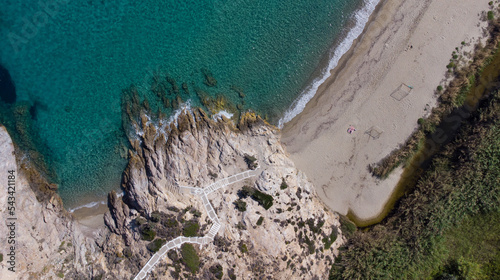 Aerial top view of Livadi Beach at the Ikaria island in a quiet summer day with blue clear water photo