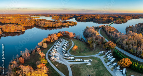 Aerial panorama view of an RV, motor home family camp site in autumn with mountains in the background on Tims Ford Lake in Tennessee USA.