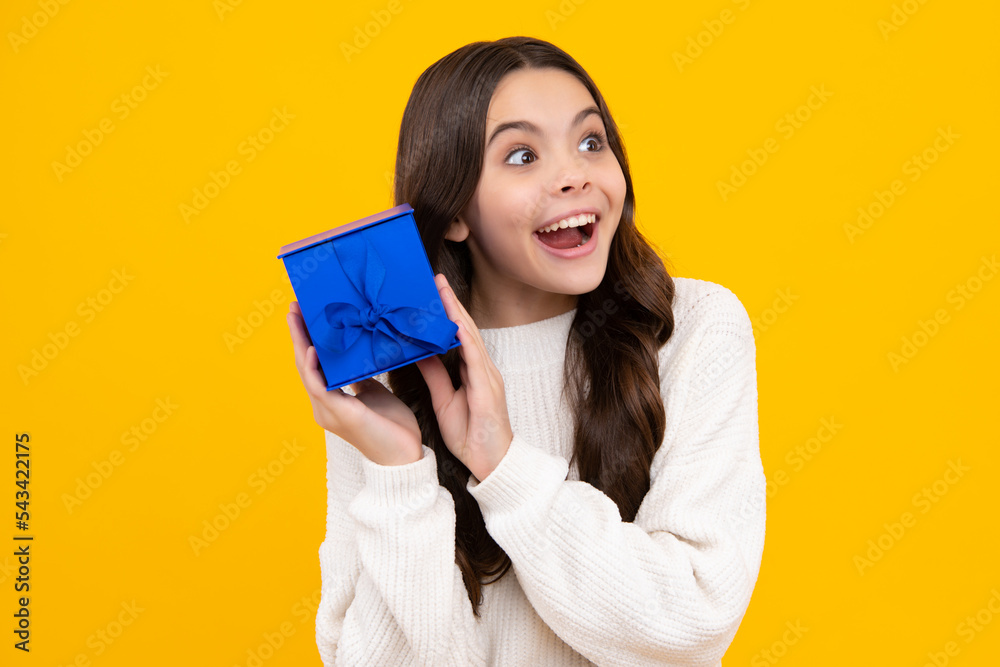 Child with gift present box on isolated background. Presents for birthday, Valentines day, New Year or Christmas. Excited teenager girl. Child with gift present box on isolated background. Presents for birthday, Valentines day, New Year or Christmas. Excited teenager girl.