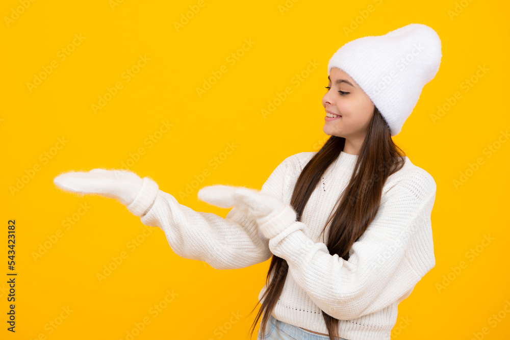 Impressed teenage girl showing recommendation copyspace. Child teenager points away, pointing aside at copy space. Impressed teenage girl showing recommendation copyspace. Child teenager points away, pointing aside at copy space.