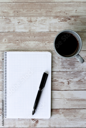 Coffee, pen and blank notebook - concept, objectives and plan of action, new year