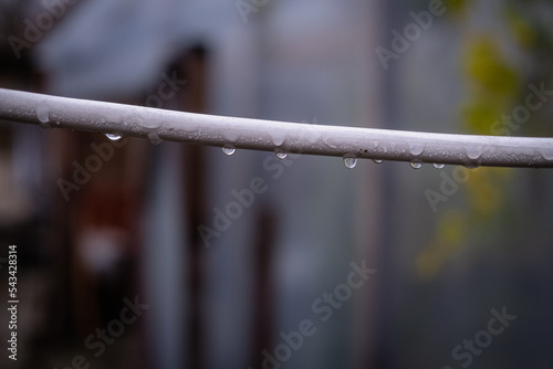 white electric cable hanging. Water drops on wire
