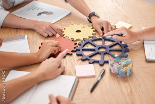Business people, teamwork and gears, solution and collaboration, planning or ideas, goals and puzzle innovation at office desk. Closeup group of employee hands, problem solving and strategy challenge