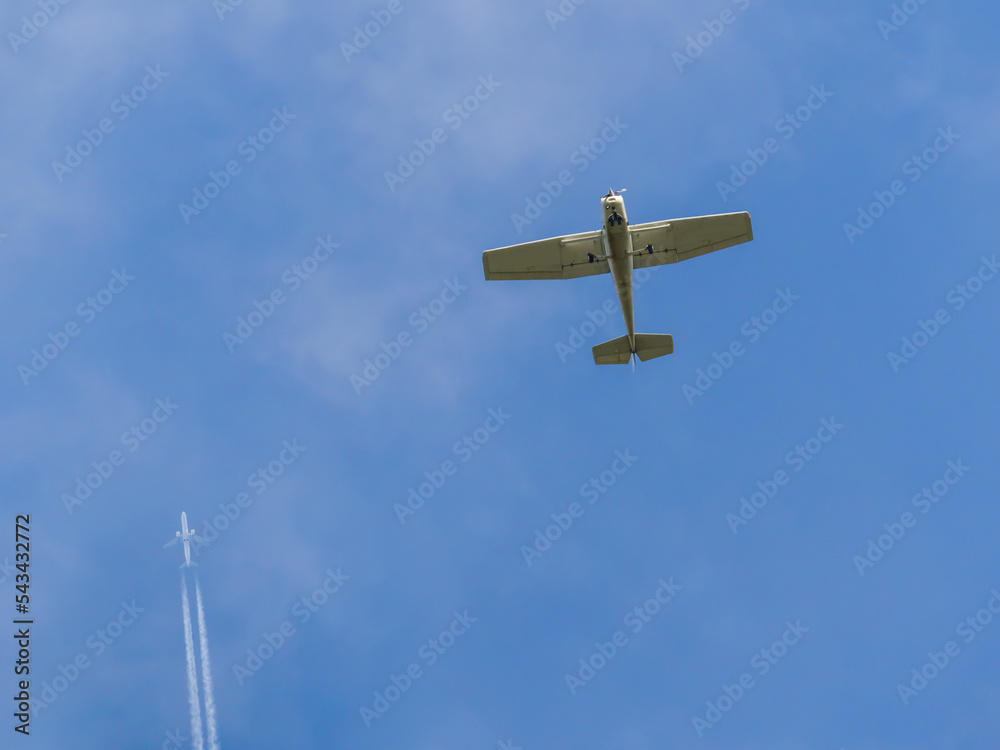Twin engine and single engine
airplanes flying in blue sky Twin engine and single engine
airplanes flying in blue sky