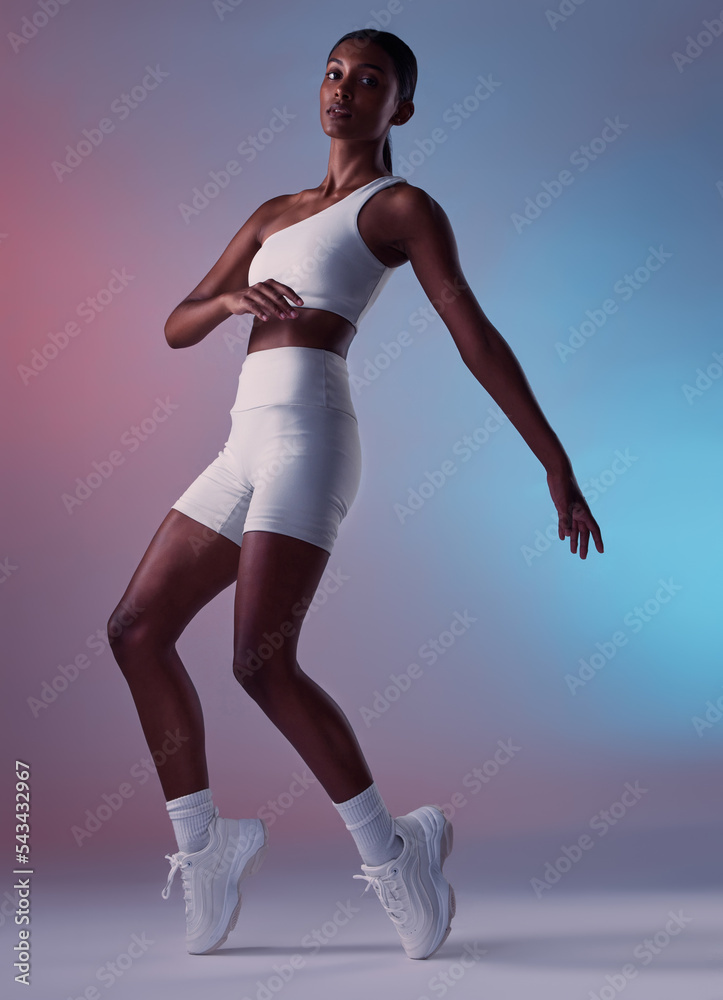 Health, fitness and sports fashion of woman on a studio background ready for workout for exercise. Strong, working out and sportswear of female with a healthy lifestyle being fit, active and training