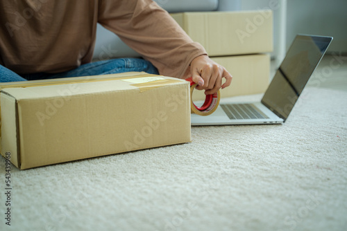 Startup small business entrepreneur,cardboard parcel box of product for deliver to customer,Online selling,E-commerce,Packing concept, © visoot