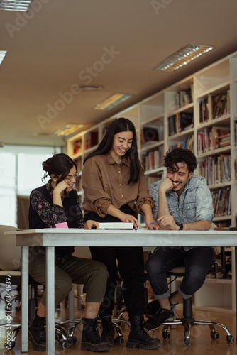Group of diverse colleagues working on the computers in the modern office or coworking space.