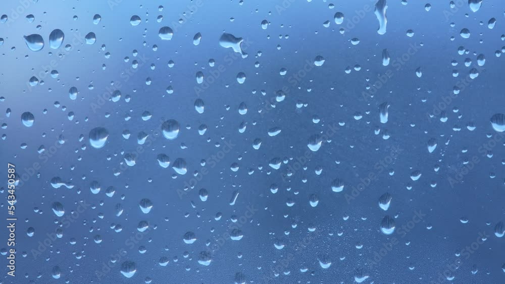Raindrops are dripping on the foggy glass close-up Raindrops are dripping on the foggy glass close-up
