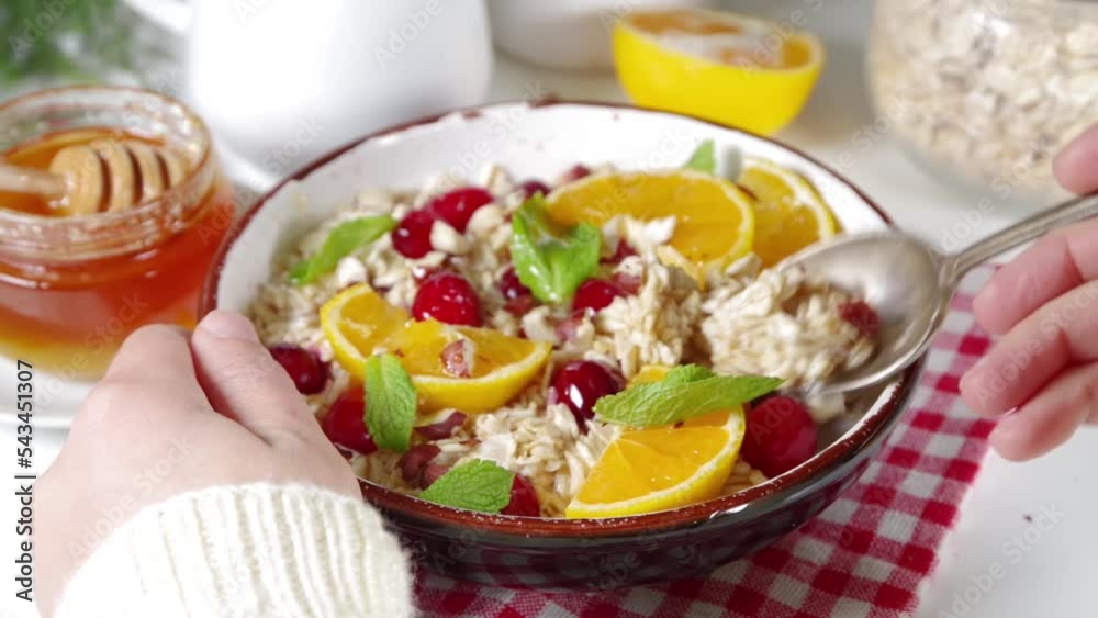 Christmas morning breakfast recipe, cranberry orange oatmeal. Making eating oats porridge with fruit and berry Christmas morning breakfast recipe, cranberry orange oatmeal. Making eating oats porridge with fruit and berry
