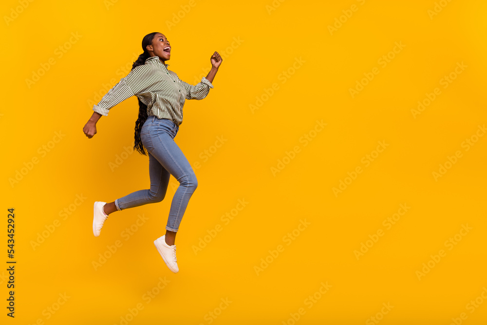 Full body profile portrait of sportive amazed girl look empty space running isolated on yellow color background