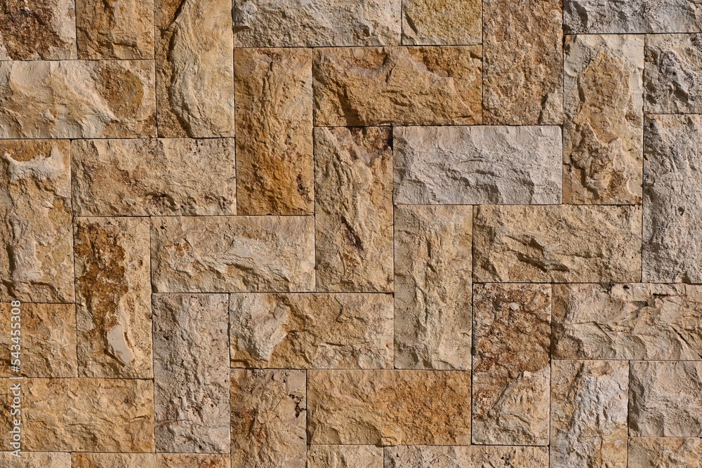 Fototapeta premium Fondo con detalle y textura de superficie de piedra con formas rectangulares y tonos marrones