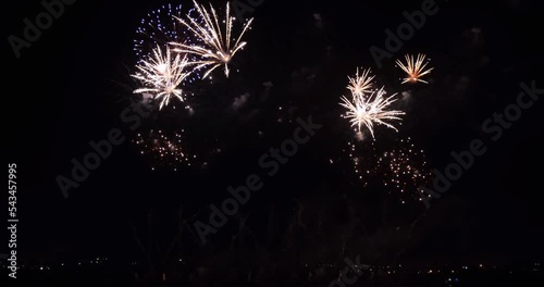 Bright festive fireworks light up the night sky. Symbol of celebration, joy, New Year's Eve, big events
