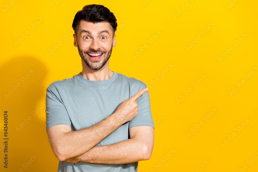 Photo of overjoyed man khaki stylish clothes arm direct empty space recommendation positive feedback isolated on yellow color background Photo of overjoyed man khaki stylish clothes arm direct empty space recommendation positive feedback isolated on yellow color background