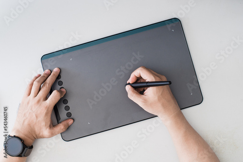 Overhead image of person drawing on drawing tablet 