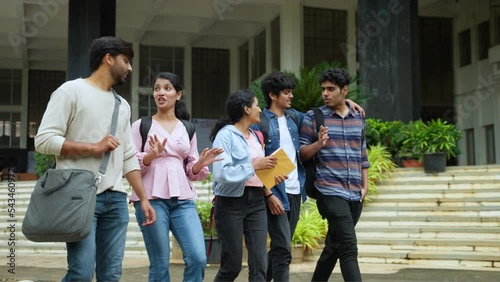 tracking shot, Group of happy students going home by talking each other after class at college campus - concept of friendship, enjoyment and millennial lifestyle.