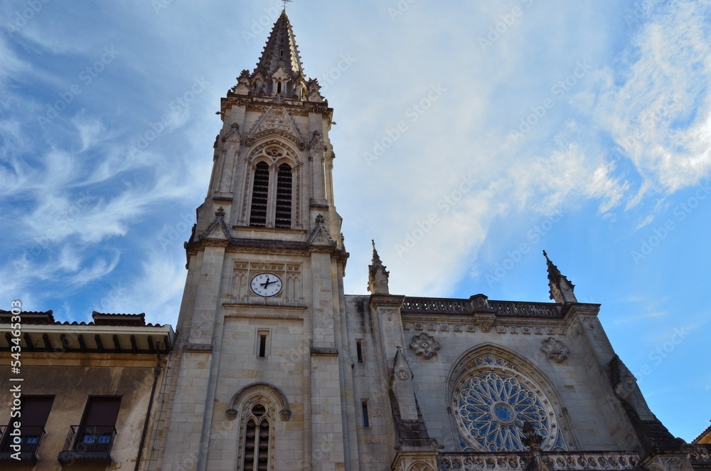 iglesia con torre y reloj con un cielo azul con alguna nube