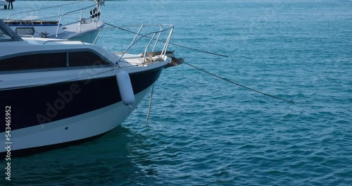 Yachts moored at the pier are rocking on the sea waves. The concept of tourism, travel. 4K video 4096x2160