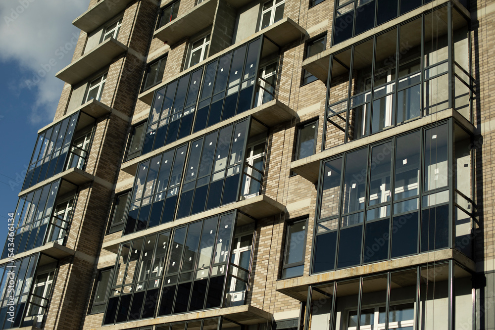 Obraz premium New building. Construction in city. Balconies and windows in house.