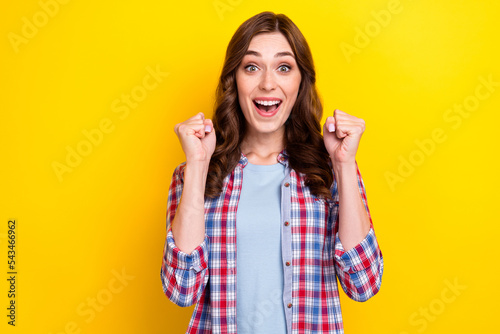 Photo of youngster adorable lady wear stylish checkered shirt hands up hooray final sale low prices clothes isolated on yellow color background © deagreez