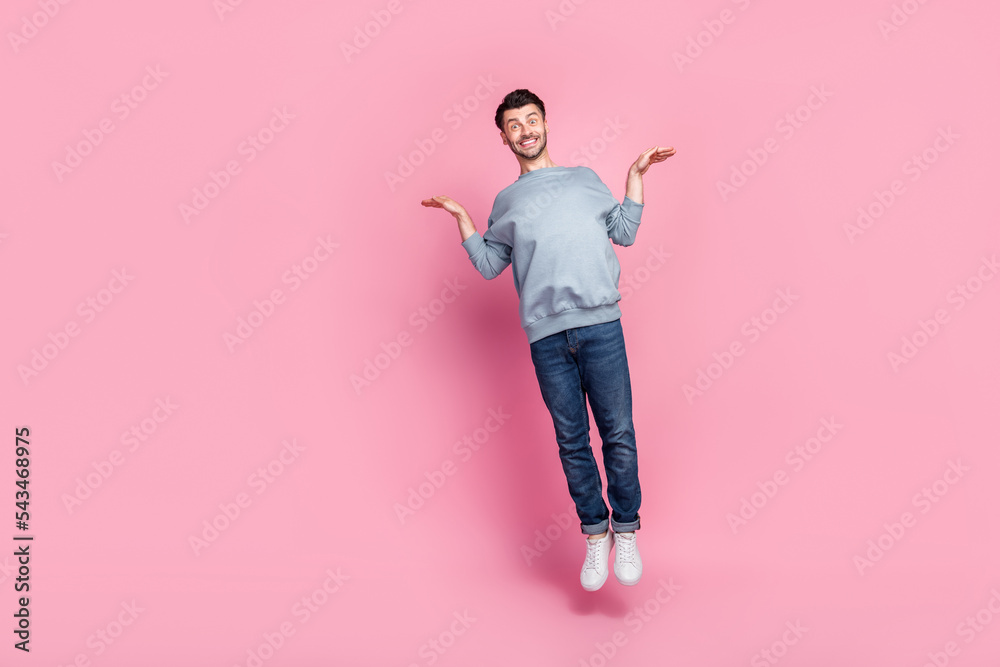 Full body size photo of young attractive funny handsome toothy guy grimace hands like wings fly high bird crazy big sale isolated on pink color background