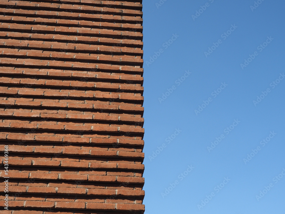 red brick wall over blue sky background red brick wall over blue sky background