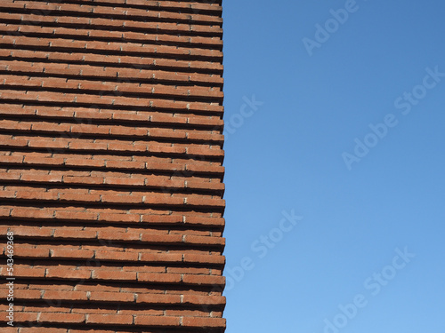 red brick wall over blue sky background
