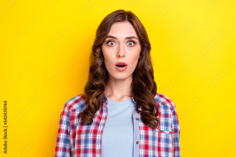 Photo of pretty impressed young girl dressed checkered shirt big eyes isolated yellow color background Photo of pretty impressed young girl dressed checkered shirt big eyes isolated yellow color background