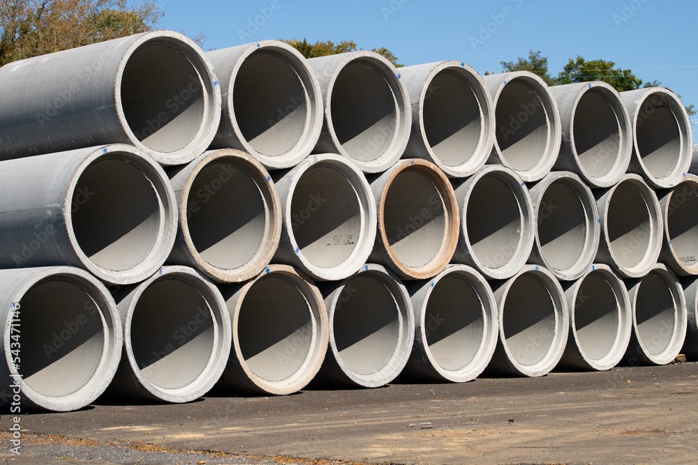Stacked cement pipes at concrete factory, outdoors warehouse Stacked cement pipes at concrete factory, outdoors warehouse