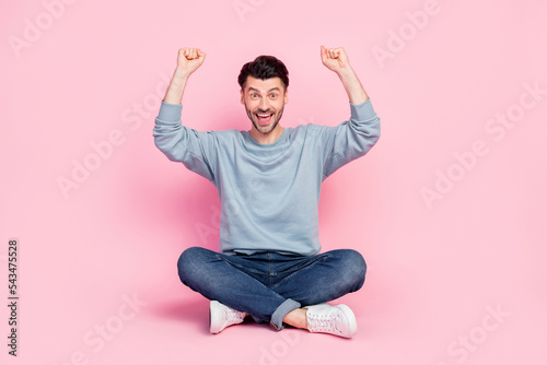 Full length photo of attractive young man lift fists support favorite sport team wear stylish blue look isolated on pink color background photo