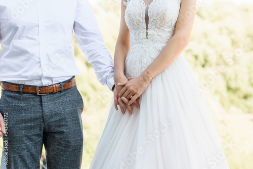 Bride and groom holding hands earnestly 