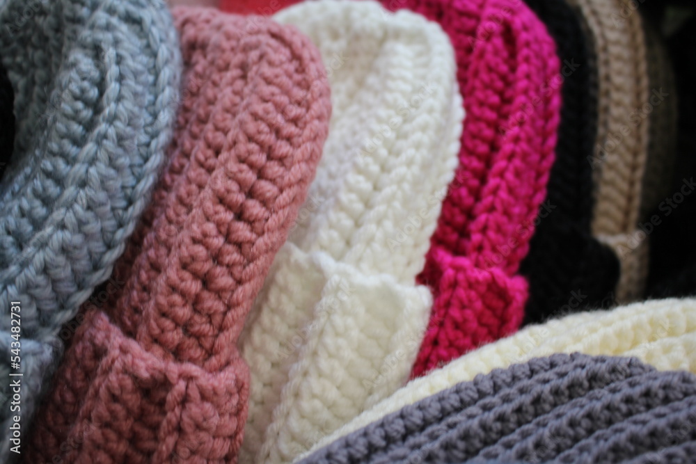 Hats crocheted knitted in the hands of a girlon the street. Product listing for sale. Urban style. Fashion. Autumn Hats crocheted knitted in the hands of a girlon the street. Product listing for sale. Urban style. Fashion. Autumn