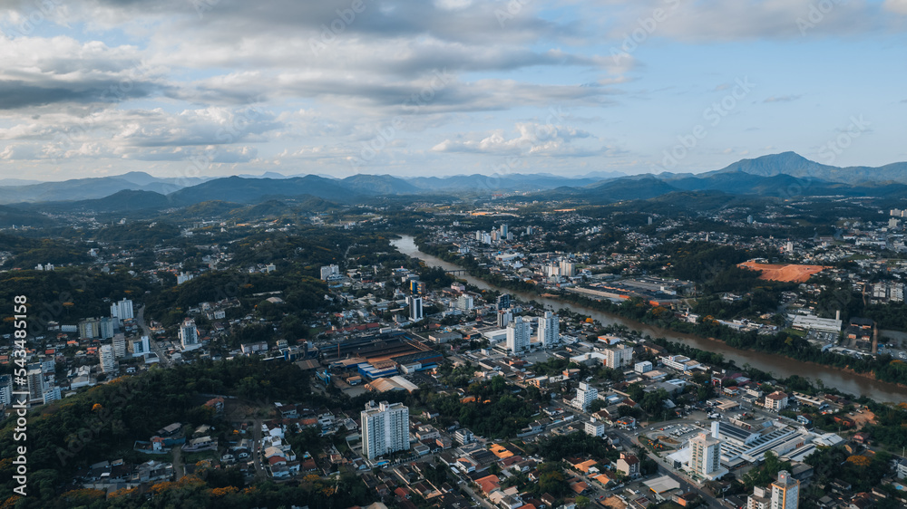 
aerial image of downtown Blumenau, with Itajaí Açú River, Santa Catarina, southern Brazil, buildings, main streets, vegetation and sunny day