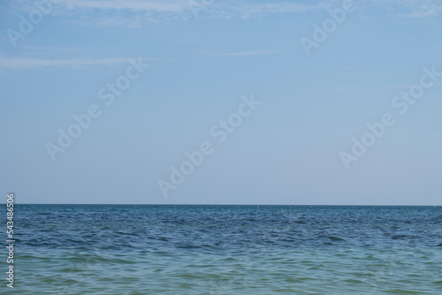 Coastal landscape and seascape. A blue horizon where cloudless sky and blue sea meet. Seascape with sea horizon and clear dark blue sky. Background. Ocean. Clear horizon line.