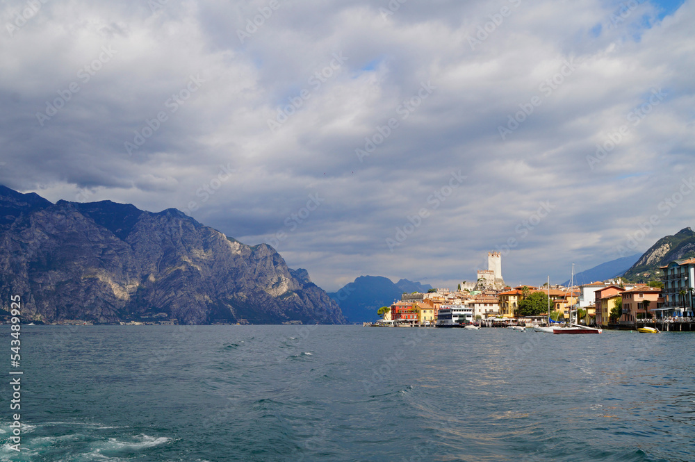 Castello Scaligero or the Scaligero Castle in the mediterranean town of Malcesine on lake Garda with the scenic Italian Alps in the background, Lombardy, Northern Italy	