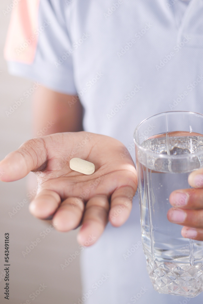unrecognized man in white shirt taking medicine unrecognized man in white shirt taking medicine