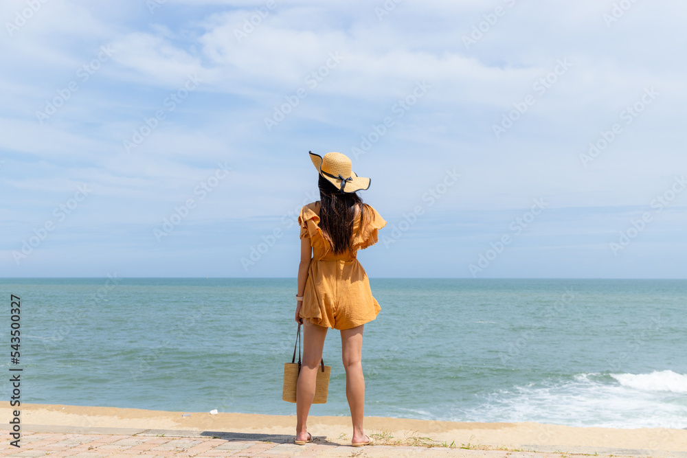 Tourist woman stand on the beach
