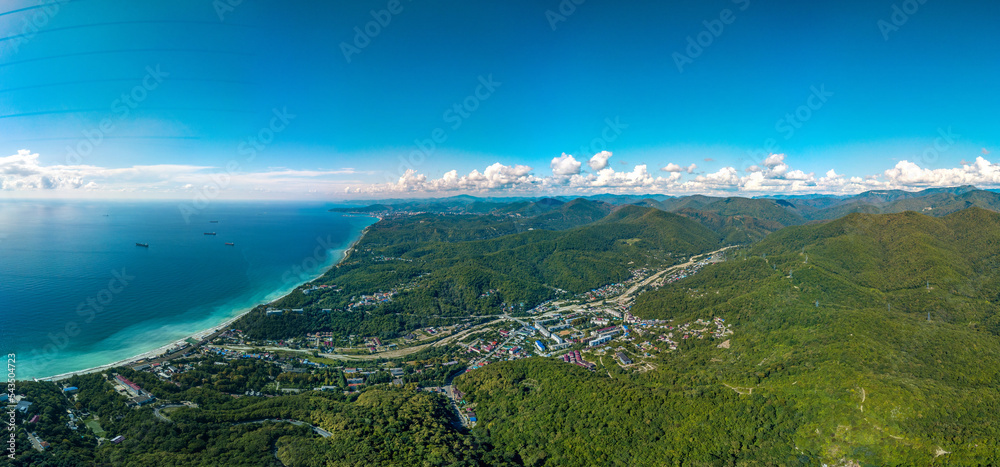 aerial full panorama view of the low mountains of the Caucasus Range near the resort village of Shepsi on a sunny summer day