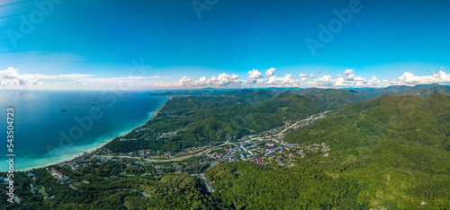 aerial full panorama view of the low mountains of the Caucasus Range near the resort village of Shepsi on a sunny summer day