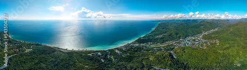 aerial panorama view of the Black Sea coast of the forested mountains of the Caucasus near the resort village of Shepsi on a sunny summer day © Alexei Merinov
