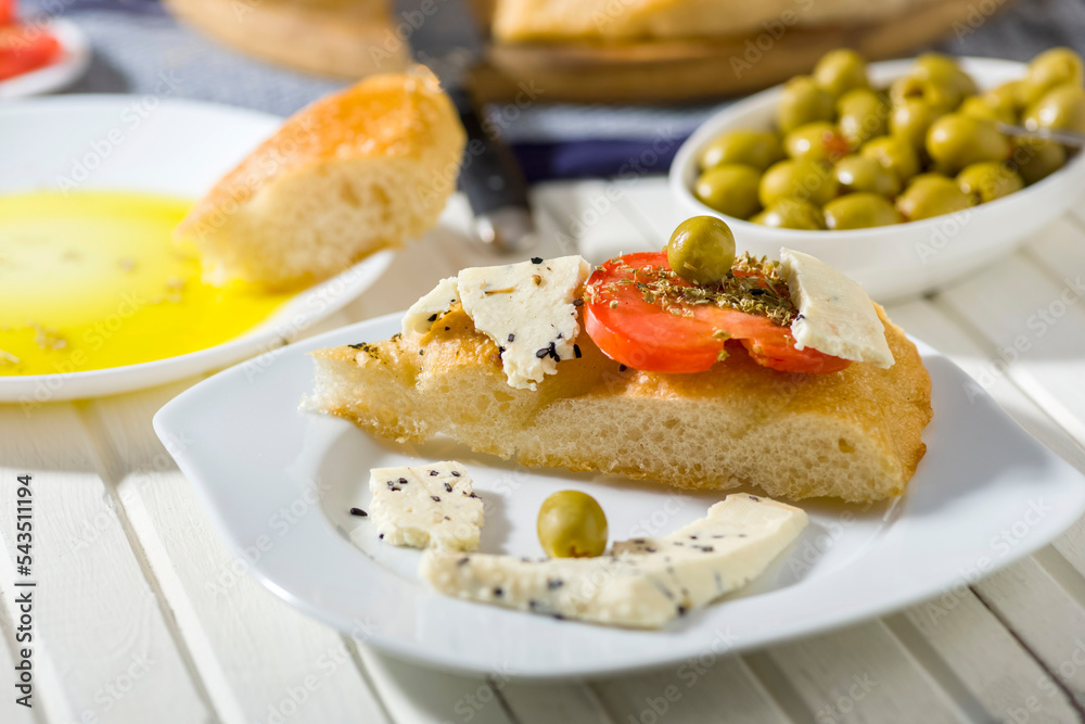 focaccia with tomatoes, cheese, olive oil and other additions focaccia with tomatoes, cheese, olive oil and other additions