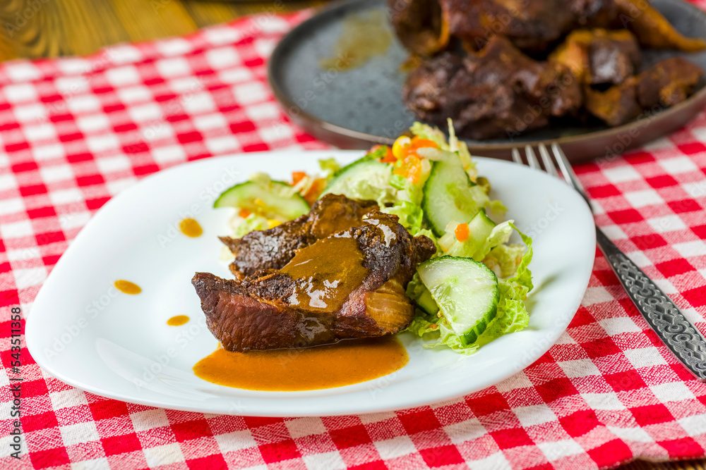 pieces of roasted pork meat and vegetable salad pieces of roasted pork meat and vegetable salad