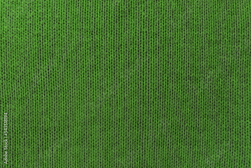 Knitted green pattern closeup, detailed yarn background.