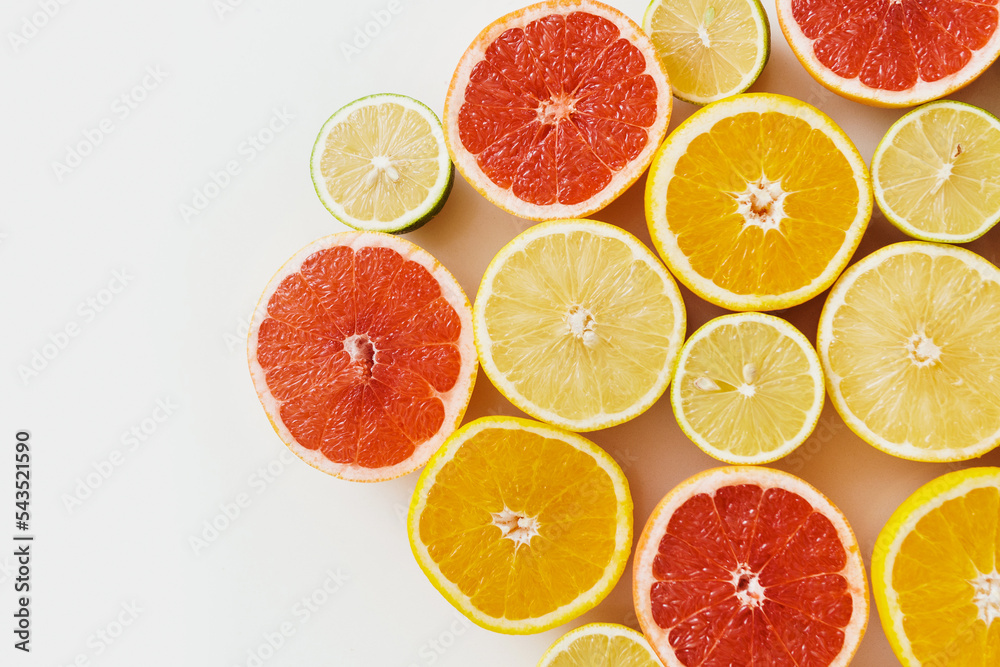 Sliced citrus fruits such as grapefruit, orange, lemon and lime on white background Sliced citrus fruits such as grapefruit, orange, lemon and lime on white background