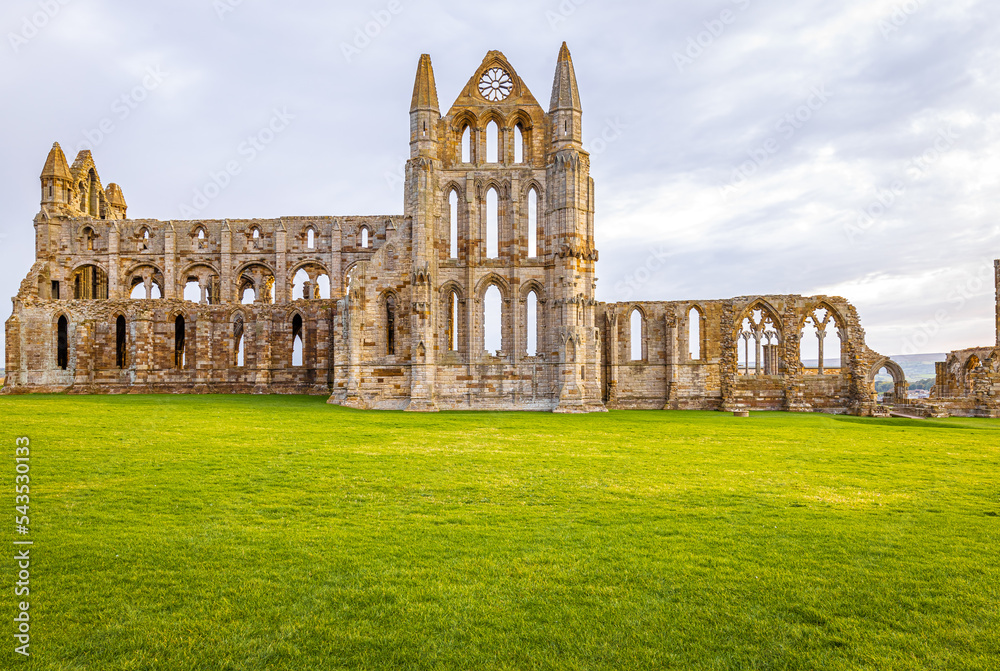 Fototapeta premium Sunset view of Whitby abbey overlooking the North Sea on the East Cliff above Whitby in North Yorkshire, England