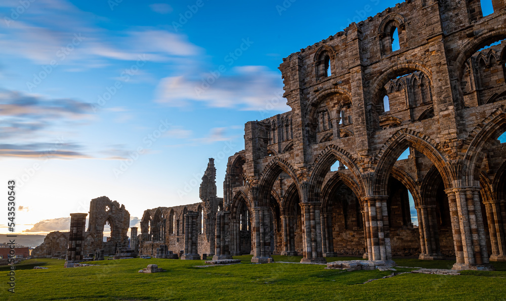 Sunset view of Whitby abbey overlooking the North Sea on the East Cliff above Whitby in North Yorkshire, England