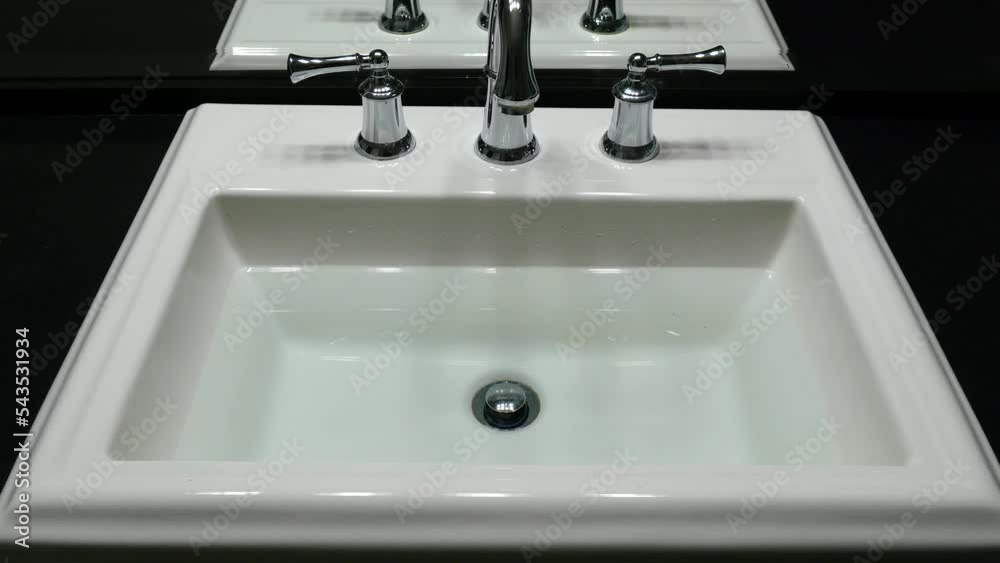 Bathroom sink full of water getting drained Bathroom sink full of water getting drained